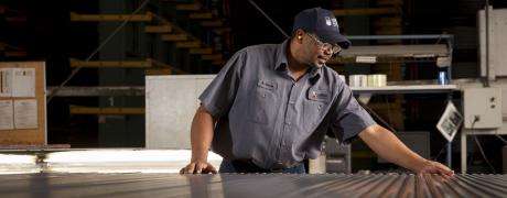 Plasti-Bond Associate Peforming Final Quality Check on Conduit Finish Line