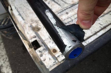 A blue interior conduit with the PVC coating failure that separated from metal surface like a peel